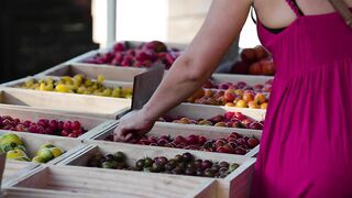 A woman choosing fruit at a market