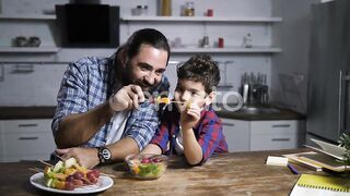 Father and Son Preparing Fruit Skewers in Kitchen