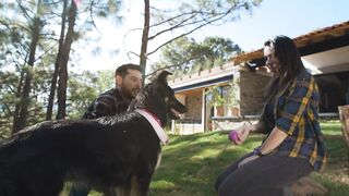 Garden Playtime: A Couple Bonds with Their Beloved Dog