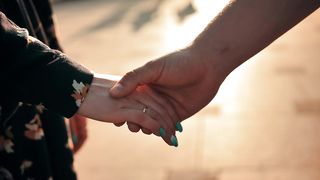 Connected Hearts: A Couple's Walk Hand in Hand