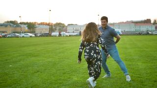 Playful Love: A Cute Couple's Joyful Romp on the Grass