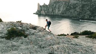 Exploring rocky shoreline and looking at horizon