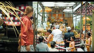 Observing a Local Balinese Ceremony: A Woman Watches a Traditional Ceremony in Bali's Nusa Penida