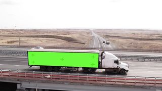 A Journey Through the Countryside: A Large Truck Drives Along a Rural Highway