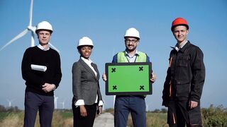 Engineers Harnessing Green Energy: A Wind Farm Team Holding a Green Screen - A Sustainable Vision for the Future