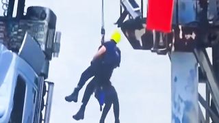 Driver rescued from truck hanging on bridge