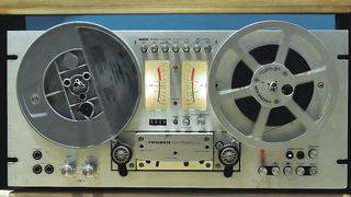 Retro audio tape recorder in motion