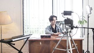 Behind the scenes of a young man recording a video.