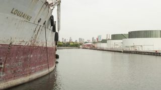 Old cargo ship waiting in the harbor