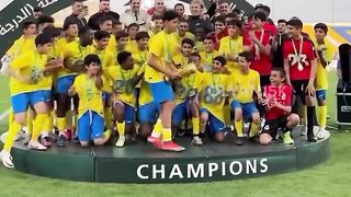 Cristiano Ronaldo Jr. lifting the trophy after winning the league with Al Nassr's U13 team
