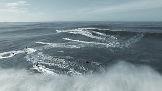 Tourists on motorboats catching waves