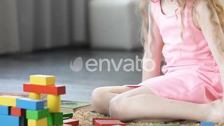 Early Education: Smart Female Kid Explores Creativity with Toy Blocks at Home