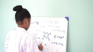 Empowering Minds: African American Girl in Lab Coat Unveils Mathematical and Scientific Marvels on Whiteboard