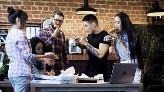 Office Bonding: Sharing Laughs and Pizza Around the Table