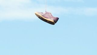 Old shoes hanging on an electric wire