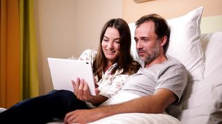 In Love and Laughter: Husband and Wife Share Heartwarming Moments Watching a Video Together