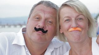 Forever Young: Senior Couple Embraces Playfulness with Fake Mustache