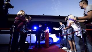 Fan Frenzy: Celebrity Couple Delights Fans by Signing Autographs"