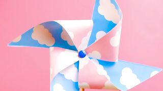 A pinwheel spinning on a pink background