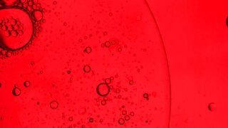 Small bubbles in a liquid on a red background
