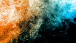 Orange and blue smoke on a black background
