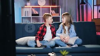 Brother and sister watch Tv