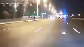 The guy is riding at high speed on an electric scooter