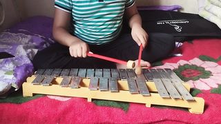 Abdullah playing xylophone