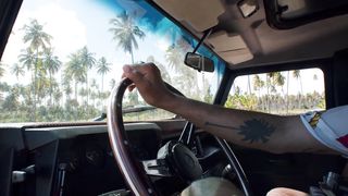 One hand on the steering wheel
