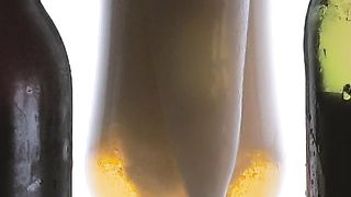 Beer foam spilling into a glass on white background