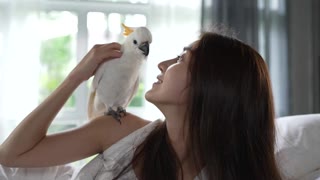 parrot kisses a girl, creating a beautiful moment: