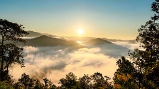 Time lapse Sunrise over mountain with mist and fog cloud