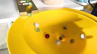 A rotating wooden marble run with lots of rolling marbles.#marblerun