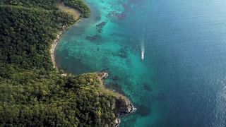 Drone Footage Of The Island With Boats In The Sea..