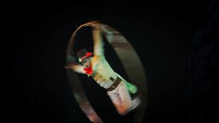 Skilful acrobat spinning in big hoop