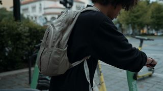 Urban Adventure: A Young Man's Commute on an Electric Scooter