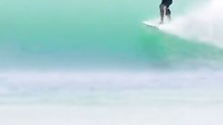 Dad rides with a child on a surfboard