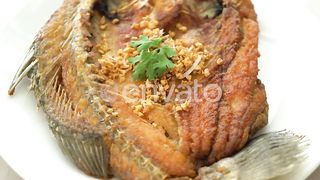 Culinary Delight: Indulging in Crispy Fried Sea Bass Fish with Garlic Infusion