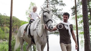 Magical Moments: A Cute Little Girl's Enchanting Ride on a White Horse