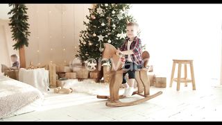 Festive Joy: A Little Boy's Magical Horseback Ride in a Christmas Wonderland