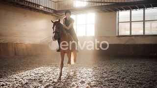 "A Moment of Connection: Happy Rider Tenderly Strokes Brown Horse's Neck During Horseback Riding