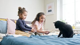 "Meow-tastic Fun: Adorable Cats Playing with Kids!"