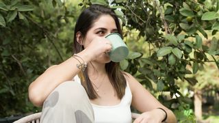 Morning Serenity: A Young Woman's Coffee & Conversations in Nature's Embrace