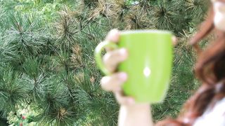 Morning Bliss: Young Woman's Coffee Moment by the Garden