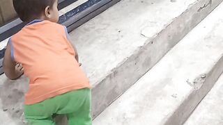 Indian Baby Playing on Roadside Luggage Shop
