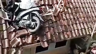 The accident involved a motorbike that got stuck on the roof of a house