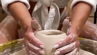 The girl works with a potter's wheel