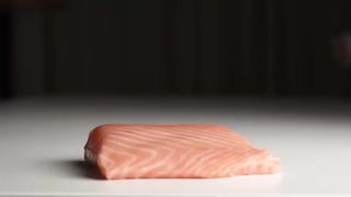 Kitten eats salmon with doom music.