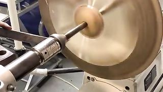 Turning a cymbal on a lathe