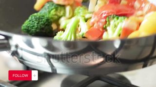 Closeup of chef cooking healthy organic fresh vegetable in a pan.